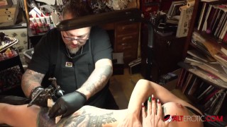 Marie Bossette touches herself while being tattooed